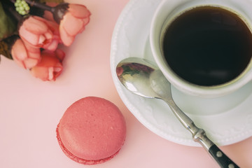 Pink macaron, macaroon and cup of coffee, spring flowers, tender pastel background. Romantic morning Dessert, gift, present for beloved