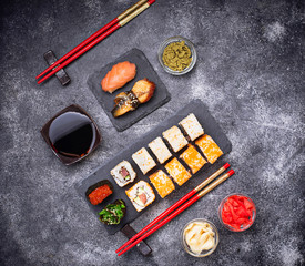 Sushi and roll set on black table