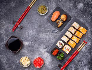 Sushi and roll set on black table