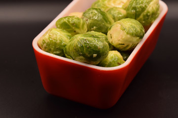 Seasoned Brussel sprouts on a black background. 