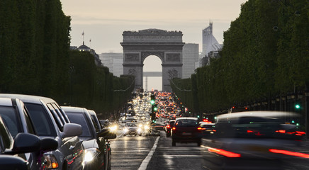 Long exposure photo of street traffic near Arc de Triomphe, Champs Elysees boulevard. Paris, France