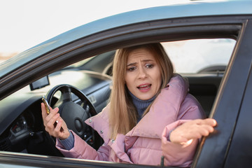 Fototapeta na wymiar Emotional woman inside car in traffic jam