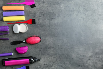 Flat lay composition with professional hairdresser tools on grey background