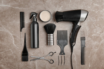 Flat lay composition with professional hairdresser tools on color background