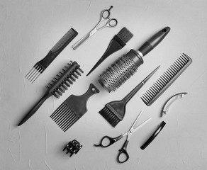 Fototapeta premium Flat lay composition with professional hairdresser tools on grey background