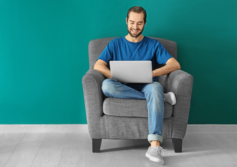 Young man using laptop indoors