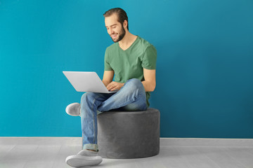 Young man using laptop indoors