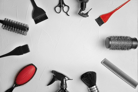 Flat lay composition with professional hairdresser tools on grey background
