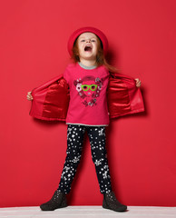 Five years old baby girl child kid posing in red leather jacket and hat screaming yelling