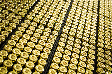 Hundreds of brass ammo rounds lined together - obrazy, fototapety, plakaty
