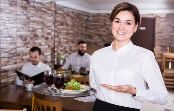 Nice waitress with tray posing