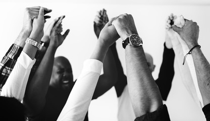 Diverse people joining hands together teamwork and winning concept