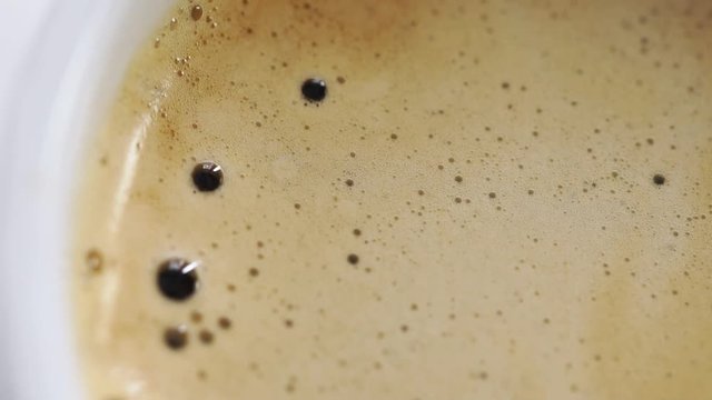 Dropping shugar into cup with coffee