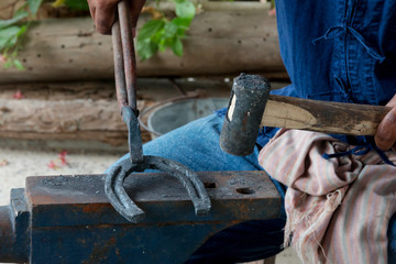 Farrier making horseshoe 
