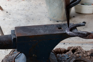 Farrier making horseshoe 
