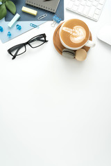 Styled stock photography navy blue office desk table with blank notebook, keyboard, macaroon, supplies and coffee cup. Top view with copy space. Flat lay.