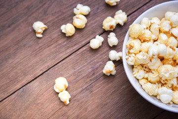 A bowl of popcorn on a wooden table
