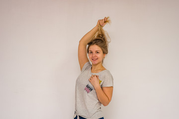 beautiful girl in different poses shows different emotions on different backgrounds in different clothes