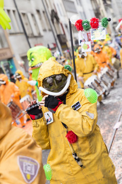 Basel carnival. Falknerstrasse, Basel, Switzerland - February 21st, 2018. Close-up of a carnival participant in orange costume