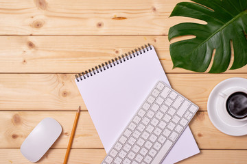 Flat lay photo of work space desk with computer keyboard, coffee cup and paper note with copy space background.
