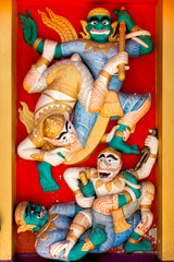Colorfu  stucco of Hanuman and  giant.on wall at Wat Pha That Luang, Vientiane,Laos,who public domain or treasure of Buddhism