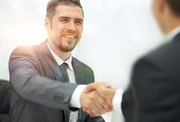 closeup .handshake of business partners on a Desk