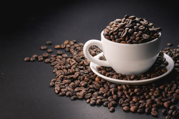 coffee in white cup and coffee beans are the background.