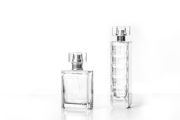 Two perfume bottles isolated on white background, fragrance spray mock up