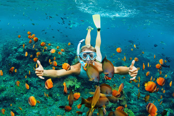 Happy family - girl in snorkeling mask dive underwater with tropical fishes in coral reef sea pool. Travel lifestyle, water sport outdoor adventure, swimming lessons on summer beach holiday with kids - obrazy, fototapety, plakaty