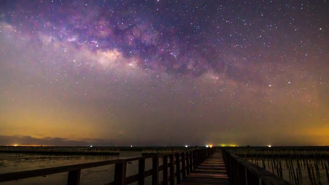 Time lapse of milky way at the bridge sea view