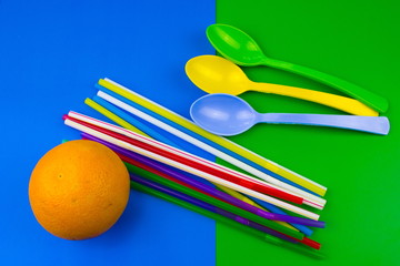 Orange, tubes and spoons. Summer concept