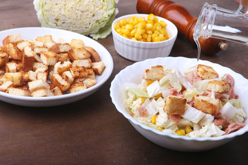 Fresh Chinese cabbage, Sweet canned corn, Delicious crispy croutons and canned tuna. Ingredients for dietary salad.