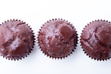 Assorted with Delicious homemade cupcakes with raisins and chocolate isolated on white background. Muffins. Top view. Copy space.