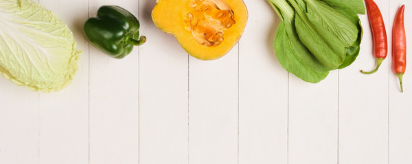 Heap of fresh fruits and vegetables on wooden background