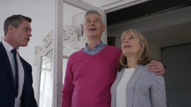 Mature couple viewing a property with a real estate agent