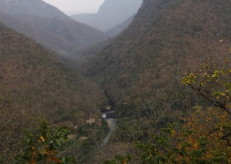panoramic view of a water resevoir and dam in a valley with mountains in the background in Northern Thailand, Southeast Asia