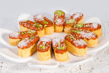 Group of Light Crunchy Puff Layered Pastry Garnished With Pistachios & Coconut Flakes Popular Persian Sweets In Iran Called Zaboon Or Zaban