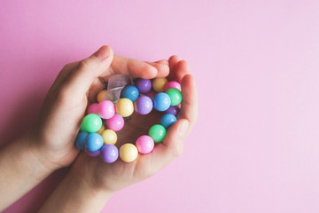 gently spring multi-colored beads in children's hands