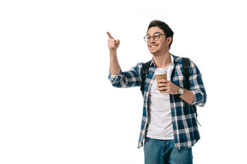 happy student holding coffee in paper cup and pointing on something isolated on white