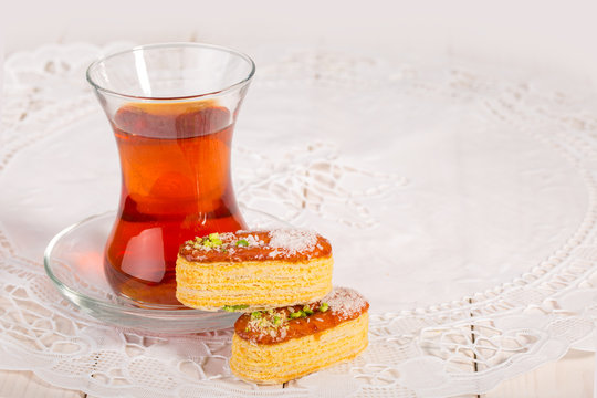 Light Crunchy Puff Layered Pastry Garnished With Pistachios & Coconut Flakes And A Traditional Cup Of Tea Popular Persian Sweets In Iran Called Zaboon Or Zaban