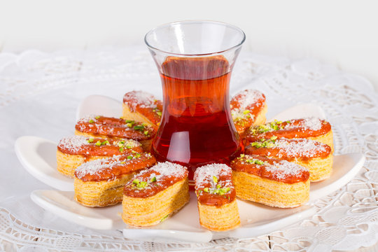 Light Crunchy Puff Layered Pastry Garnished With Pistachios & Coconut Flakes And Cup Of Tea Popular Persian Sweets In Iran Called Zaboon Or Zaban