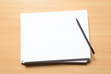 White business card on wooden table. Blank portrait A4.