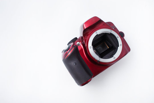 red camera with a lens on a white background