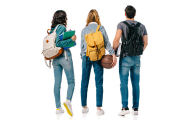 back view of multicultural students with backpacks and basketball ball isolated on white