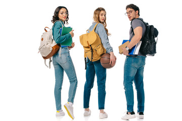 multicultural students with backpacks and basketball ball isolated on white - obrazy, fototapety, plakaty