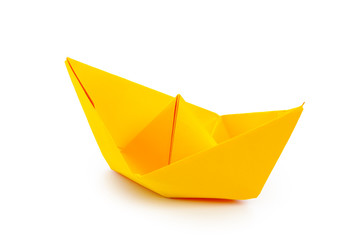 Naklejka premium origami paper boat isolated on white background