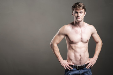 Fototapeta na wymiar Portrait of a well built shirtless muscular male model