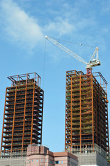 Fototapeta na wymiar A tower crane over unfinished building
