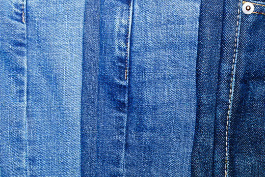 Fragment of three classic blue jeans with different shades