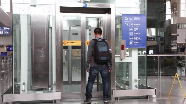 Tourists are using elevators in airport terminals.